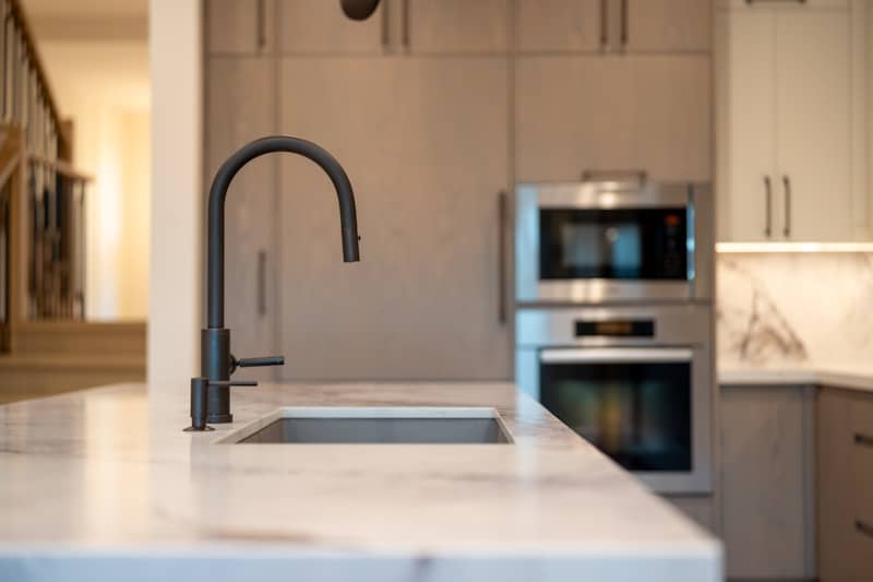 Modern kitchen sink with built-in oven and cabinets