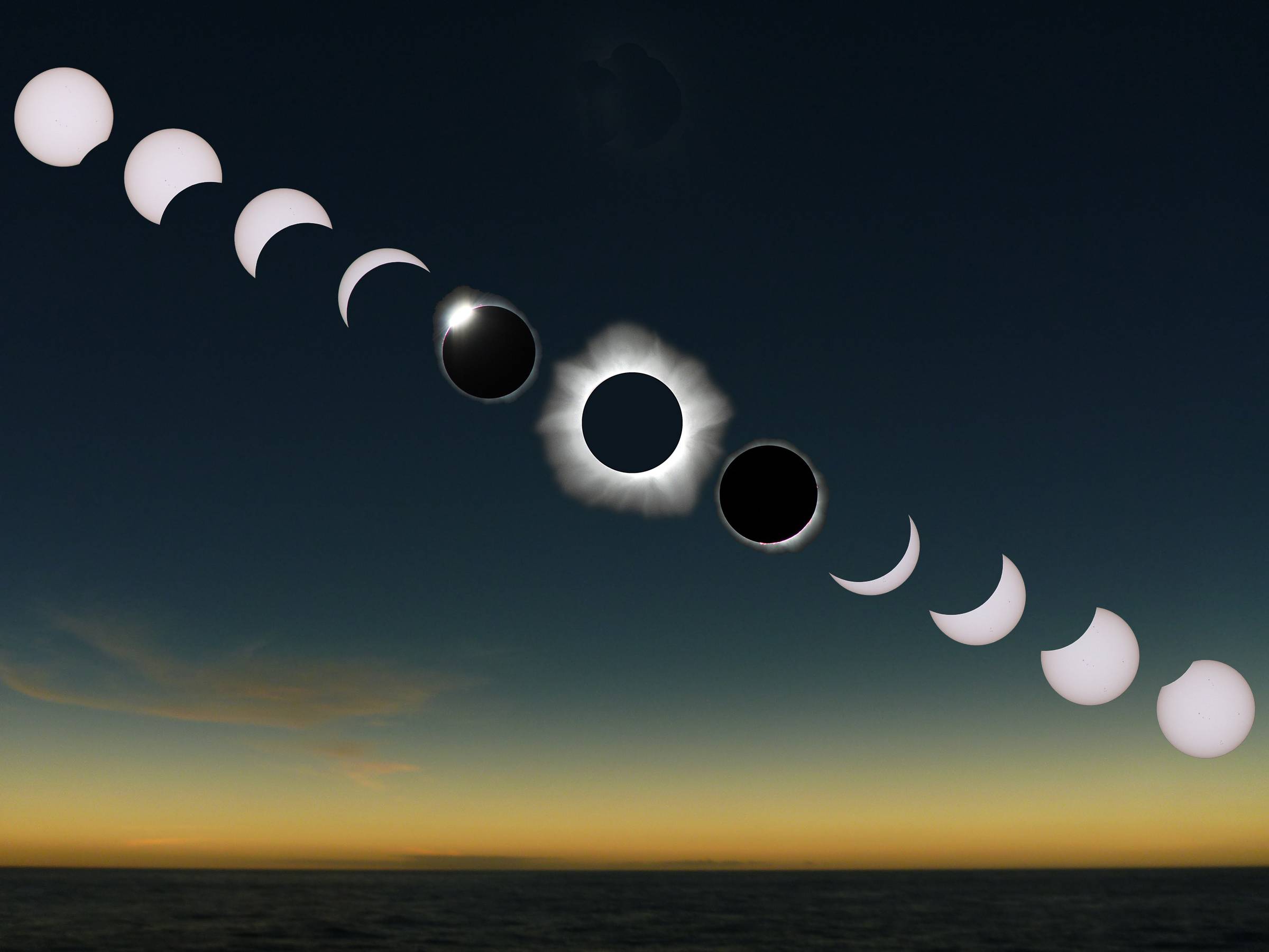 A time-lapse photo of a total solar eclipse over the ocean, showing the moon gradually moving across and then away from the sun. The sequence begins with the full sun, transitions through partial phases, reaches total eclipse with a glowing solar corona, 
