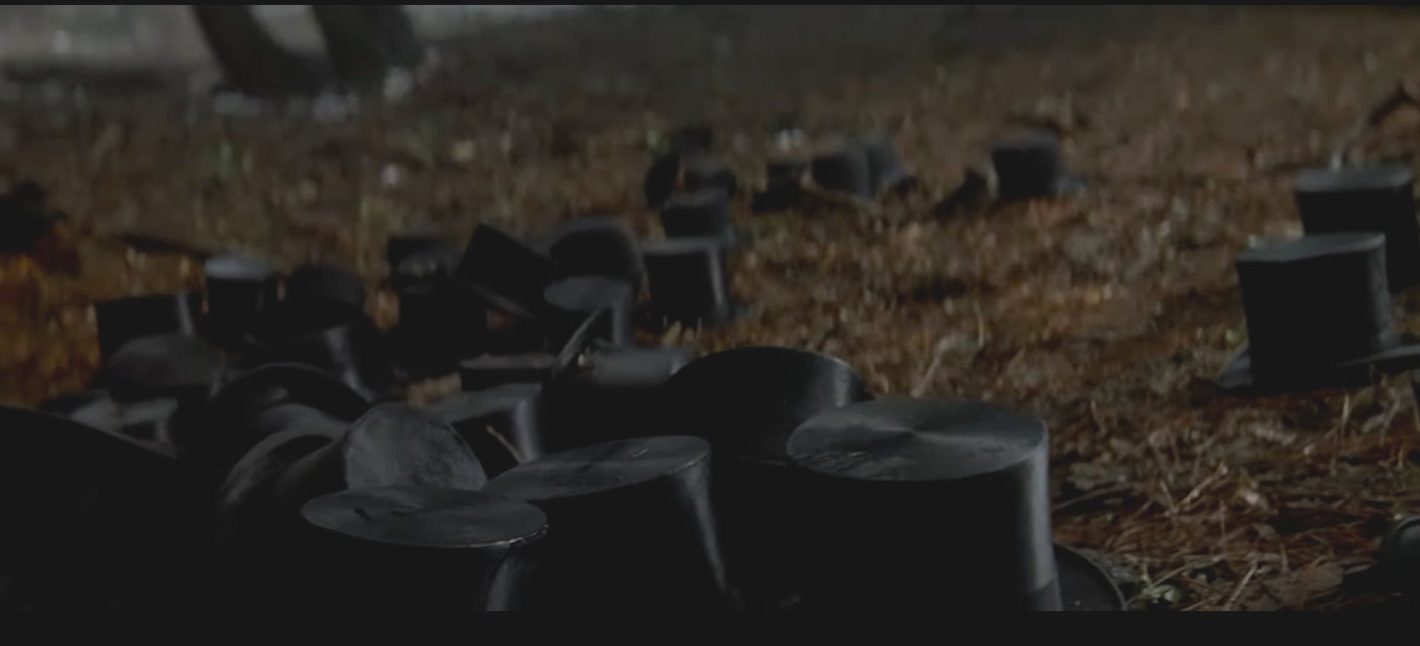 The opening image of the movie The Prestige shows a series of top-hats strewn about the forest floor. Something that will only make sense when the movie is over. 