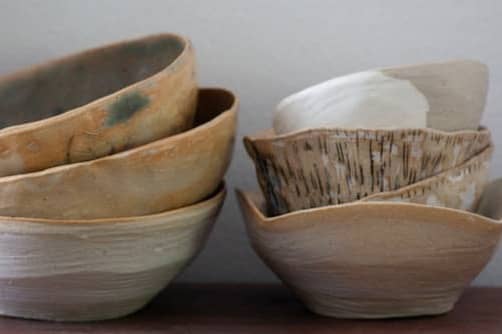 A stack of bowls sitting on top of a wooden table