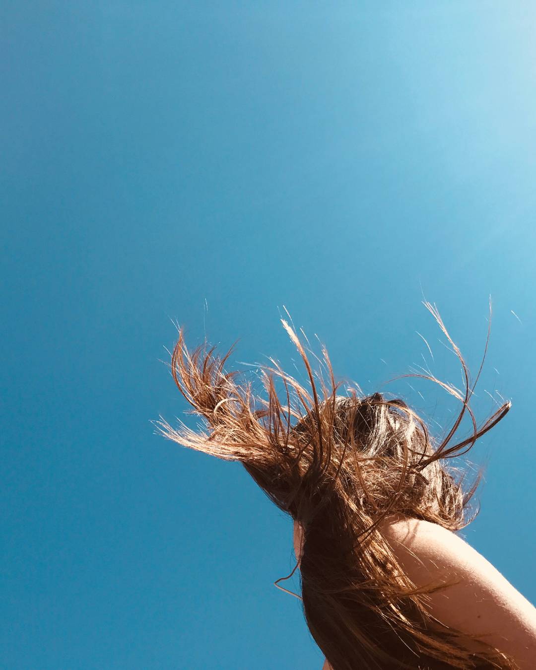 woman with long hair blowing in the wind