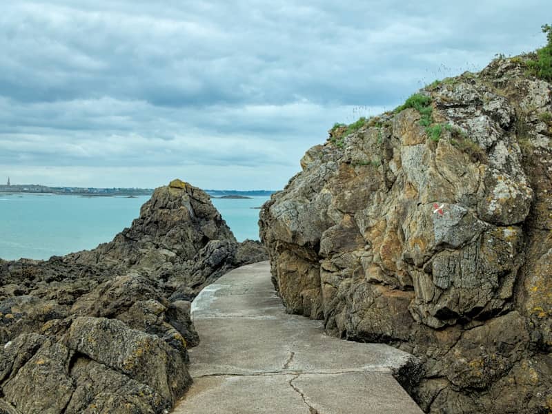 Rocky path leads towards the sea.