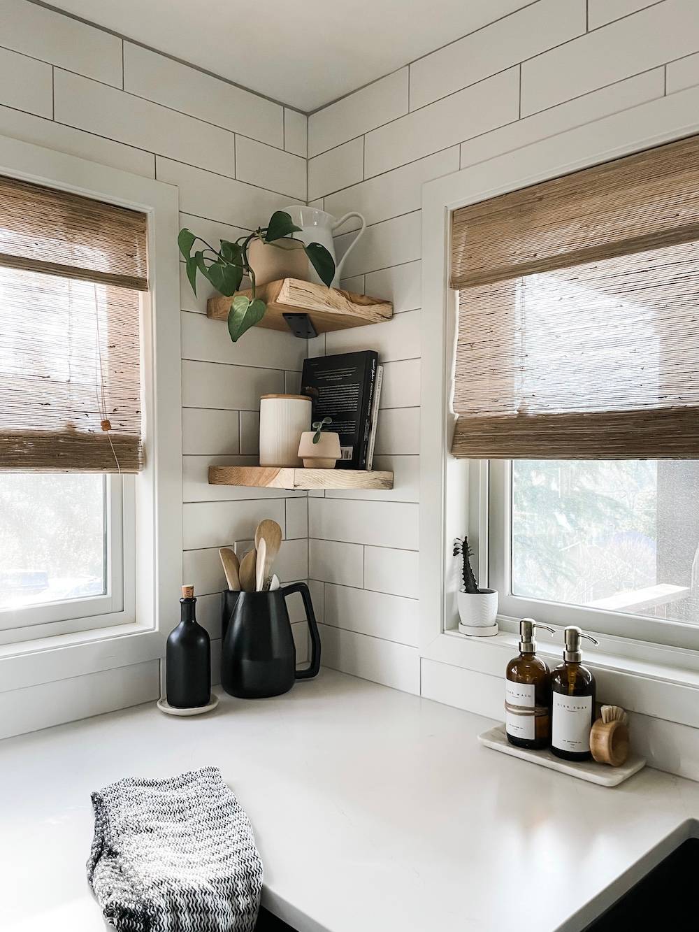 kitchen with woven wood shades and two wood corner shelves