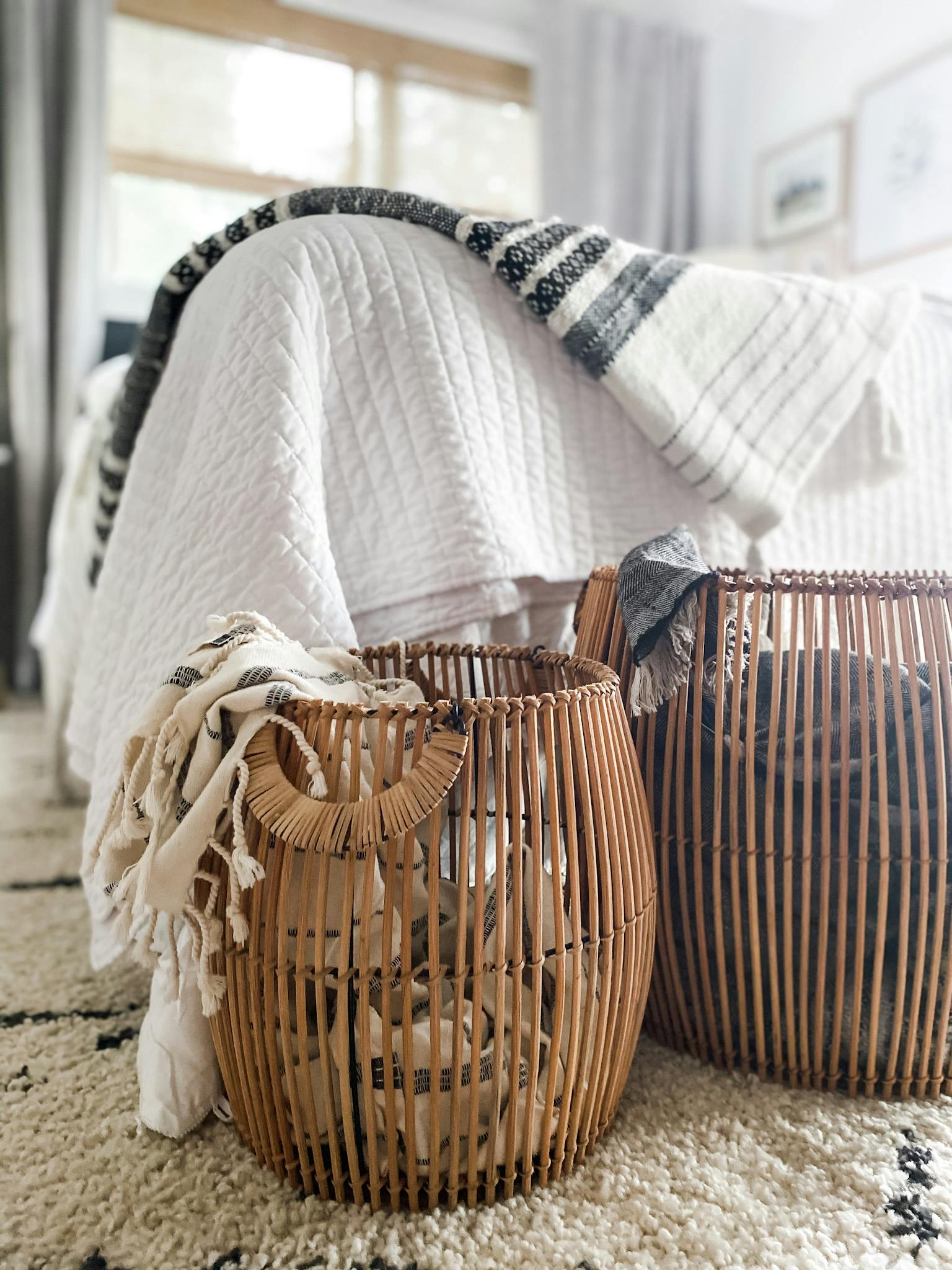 two baskets next to bed