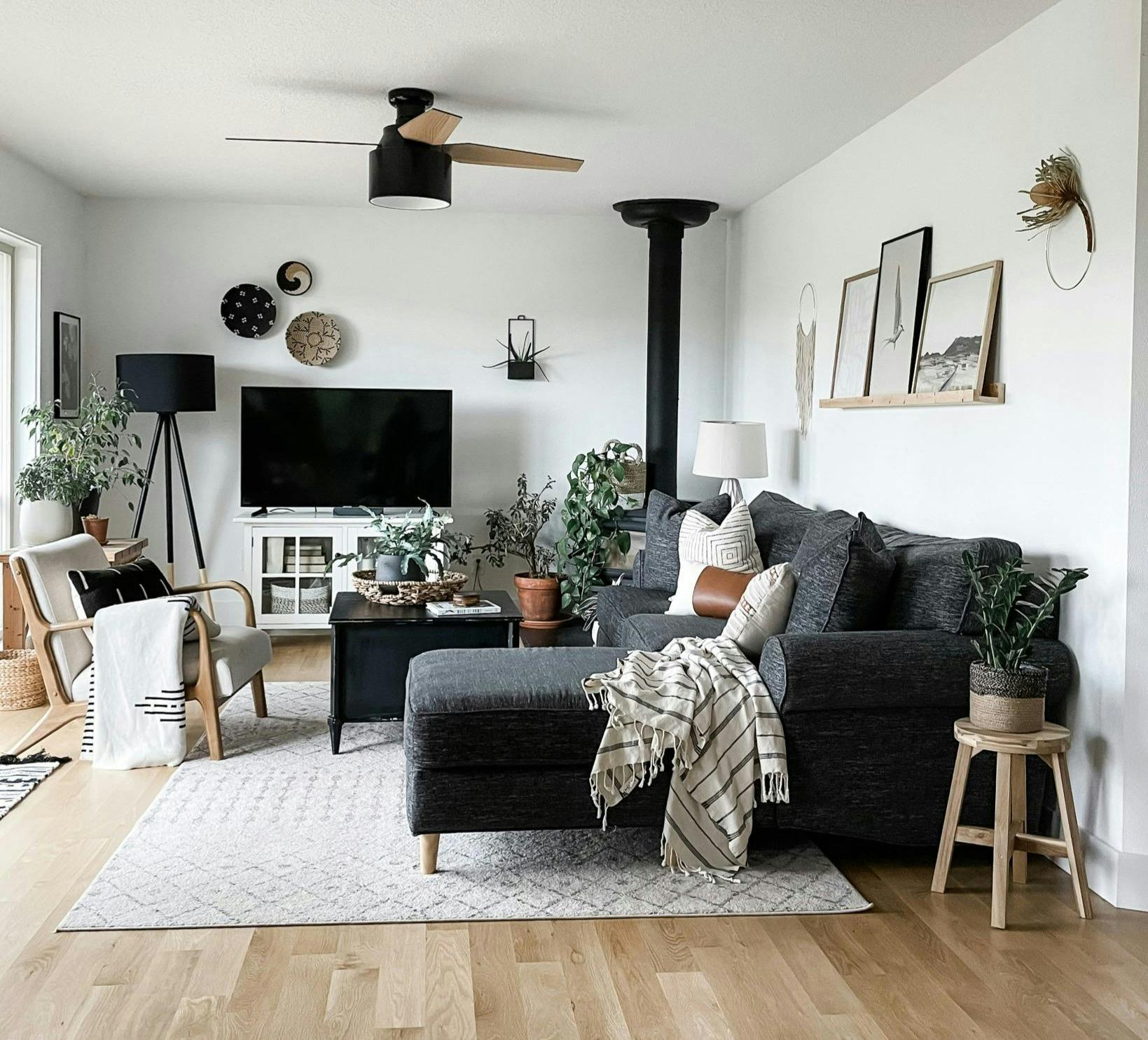 neutral living room with rug, sofa, and artwork