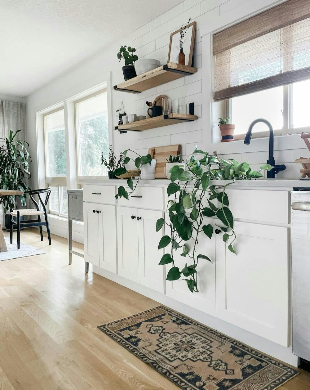 white kitchen with rug and wood shelves