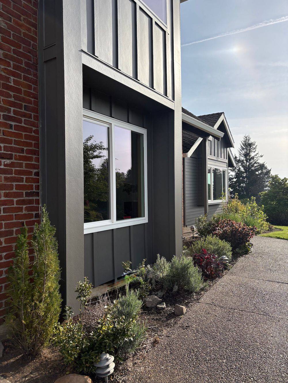 dark gray house with landscaping in front