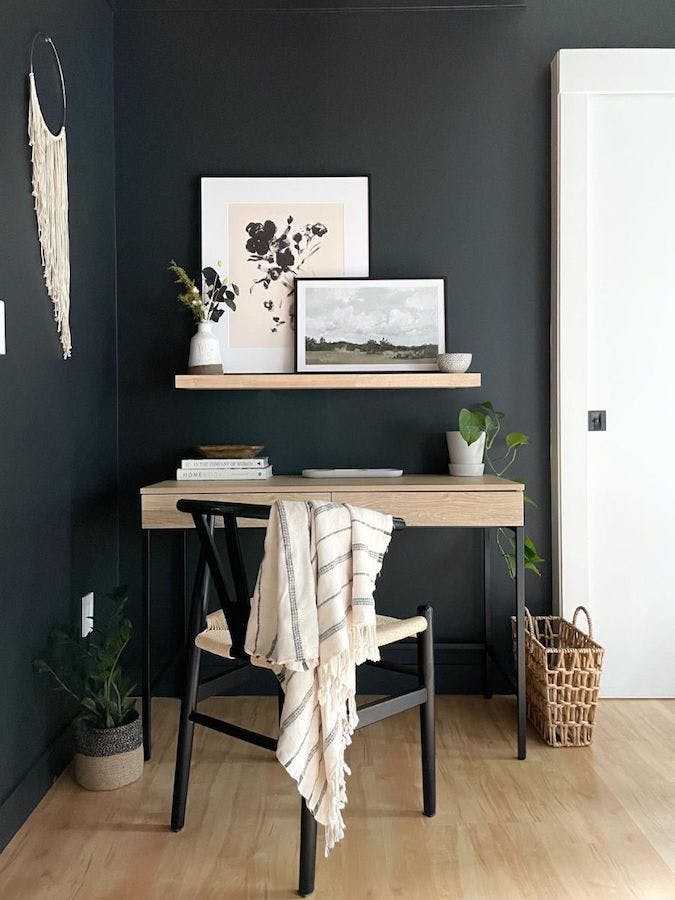corner with black walls and desk