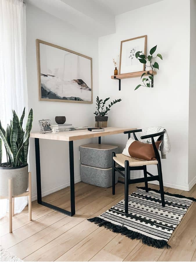 office corner nook with big desk, woven chair, and decor
