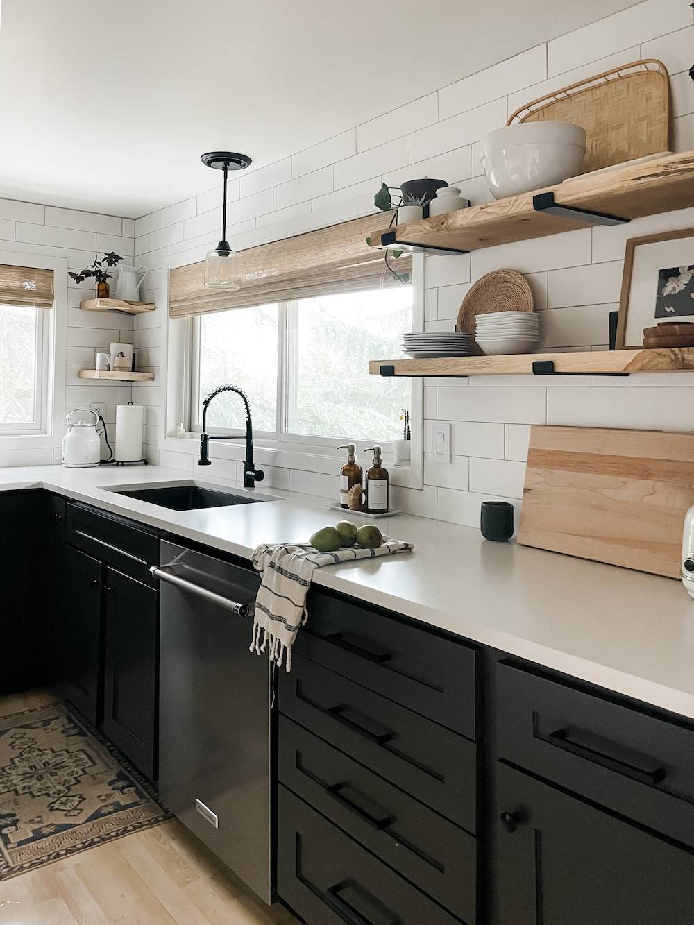 black and white kitchen with wood shelves