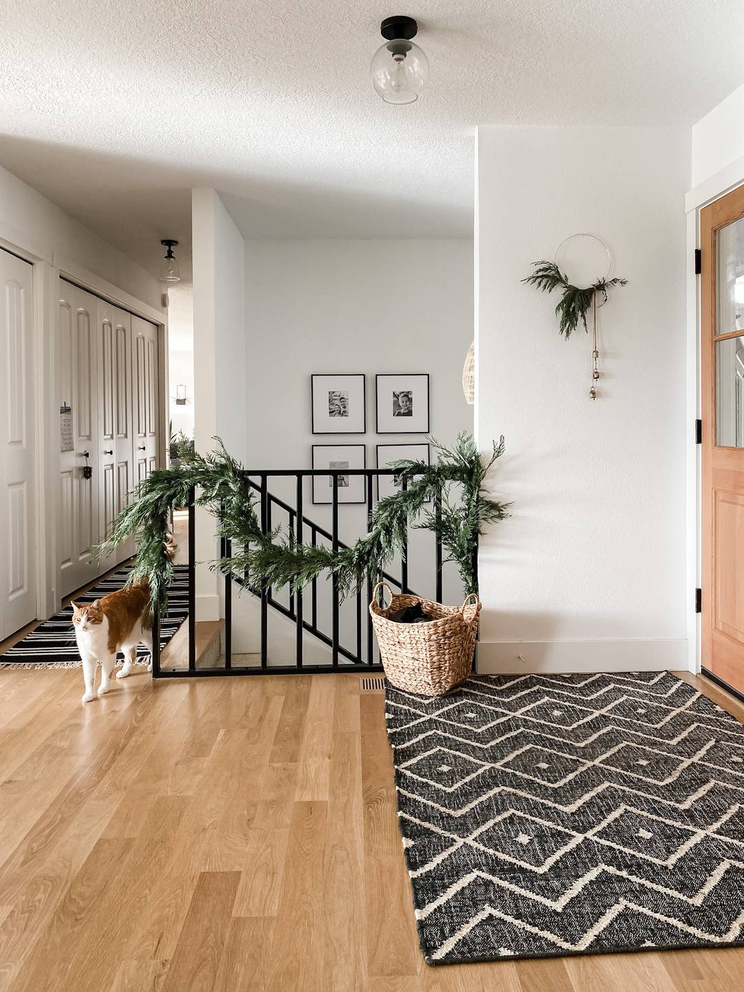 entryway with wreath and rug and basket