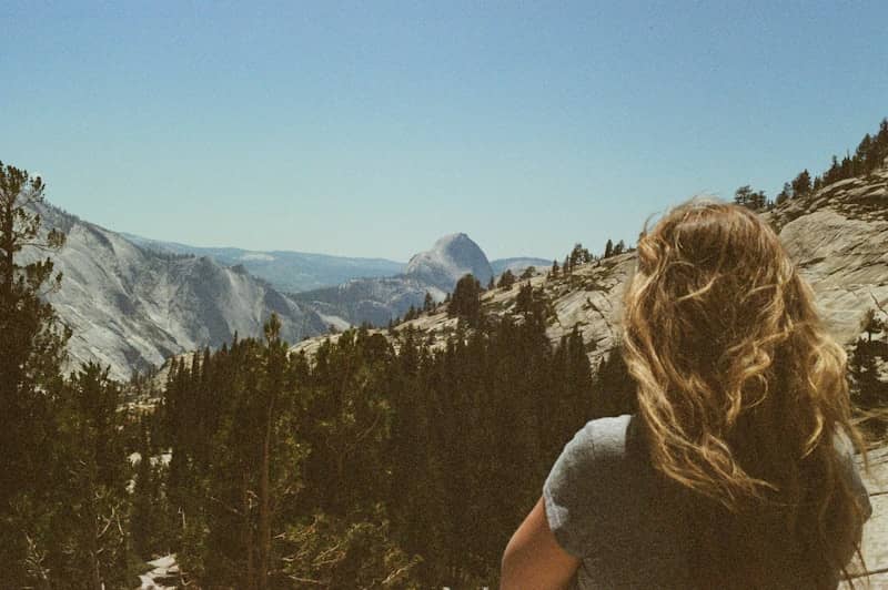 Woman looking at a vast mountain landscape