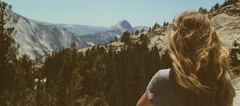 Woman looking at a vast mountain landscape