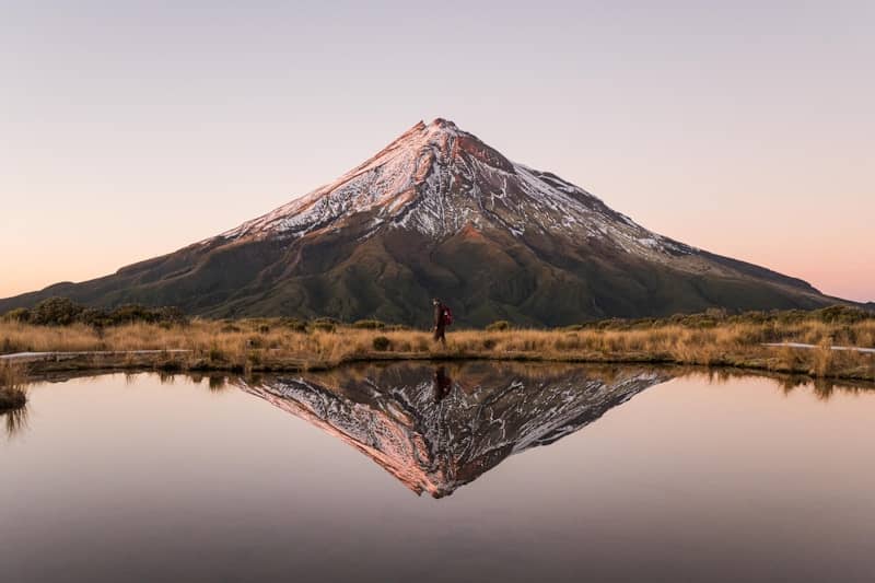 Mountain reflects beautifully in a calm, still lake.