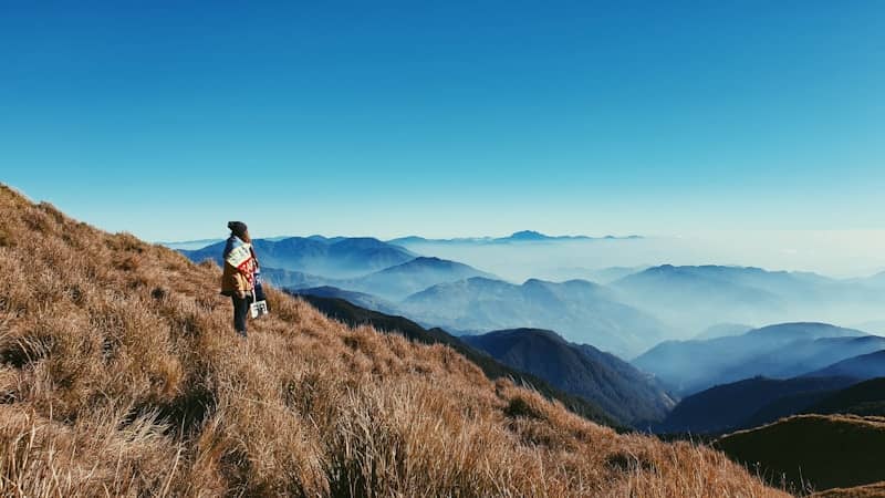 man standing on grass field