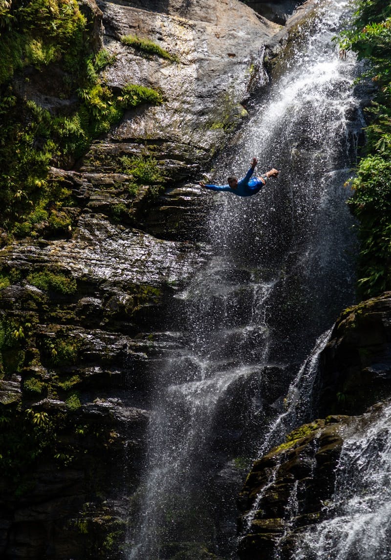 a man falling off of a waterfall into a body of water symbolizing emotional resilience