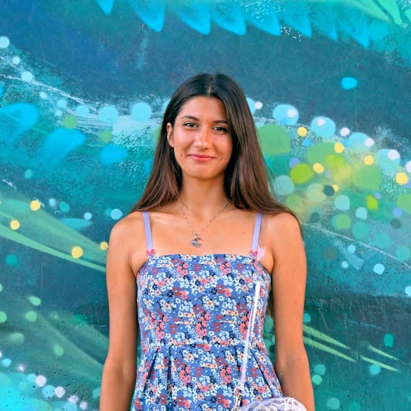 woman wearing blue and white floral spaghetti-strap dress