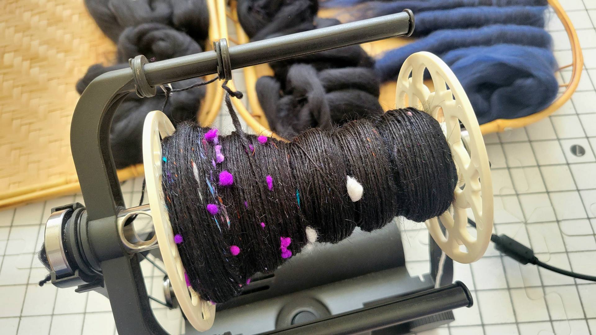 Black singles with pops of purple and white on an e-spinner.