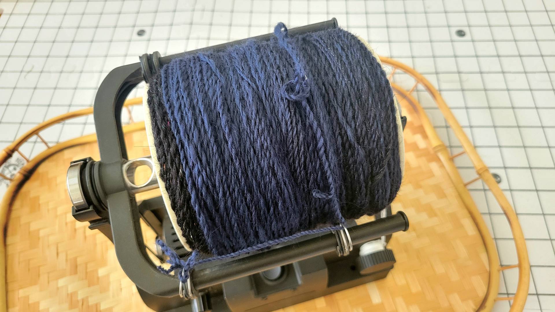Finished plied yarn showing the shift from black to navy blue.