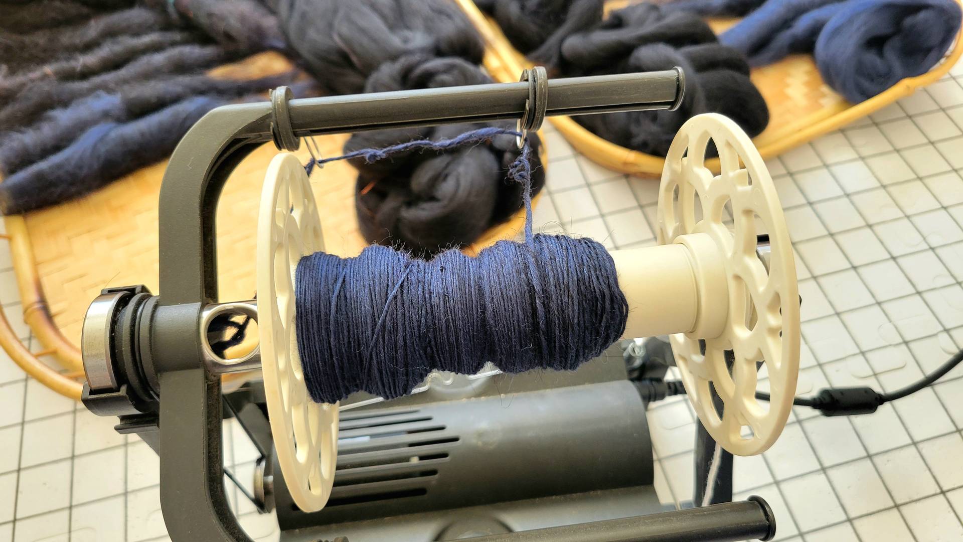 Dark navy blue singles spun on an e-spinner.
