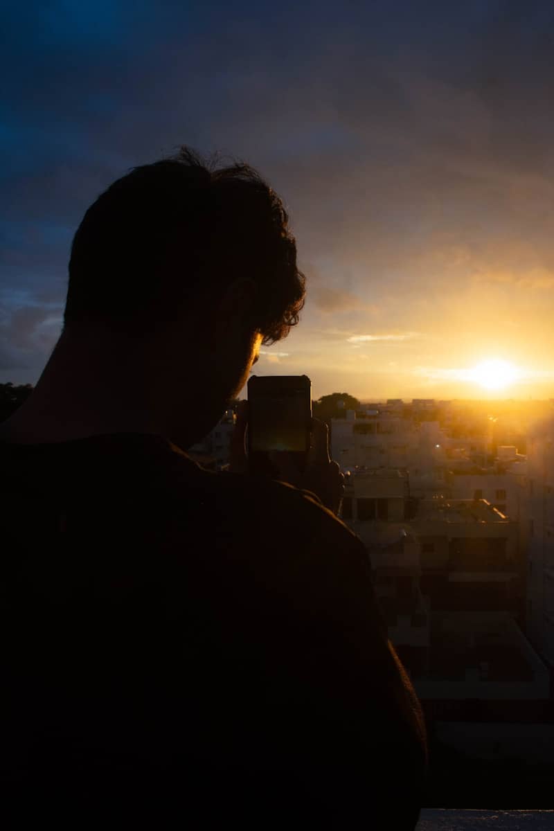 Man takes a photo of a gorgeous sunset.