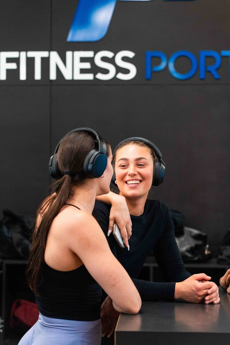 Two women sitting at a table with headphones on