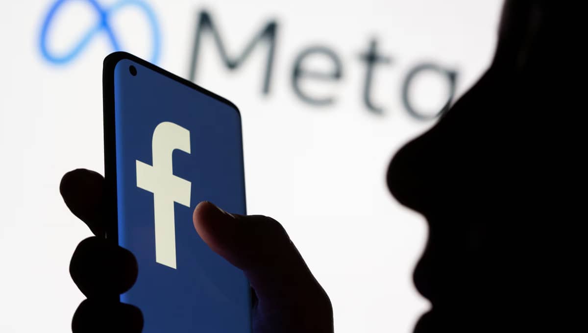 Person in shadow holding phone.