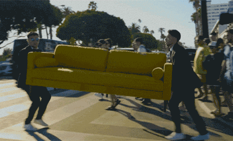 People moving furniture through crosswalk.