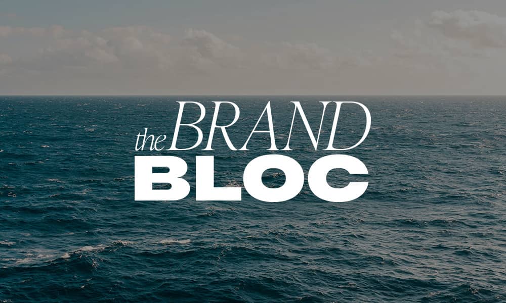 Picturesque view of the ocean with The Brand Bloc logo.