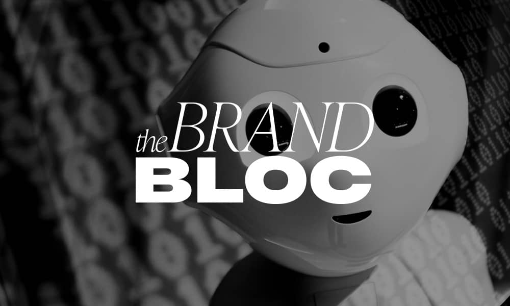 Cute robot face with The Brand Bloc logo.