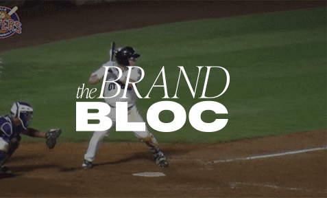 Baseball player swinging at bat with The Brand Bloc logo