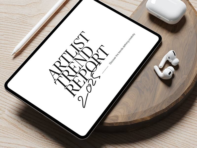 Artlist Trend Report 2025 on a tablet on wood surface