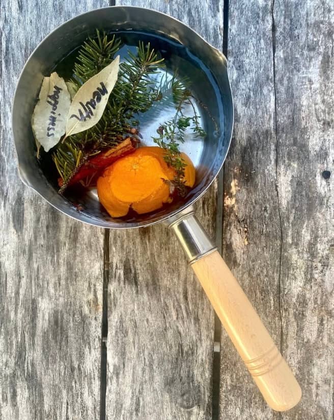 A vast starry night sky over silhouetted trees.