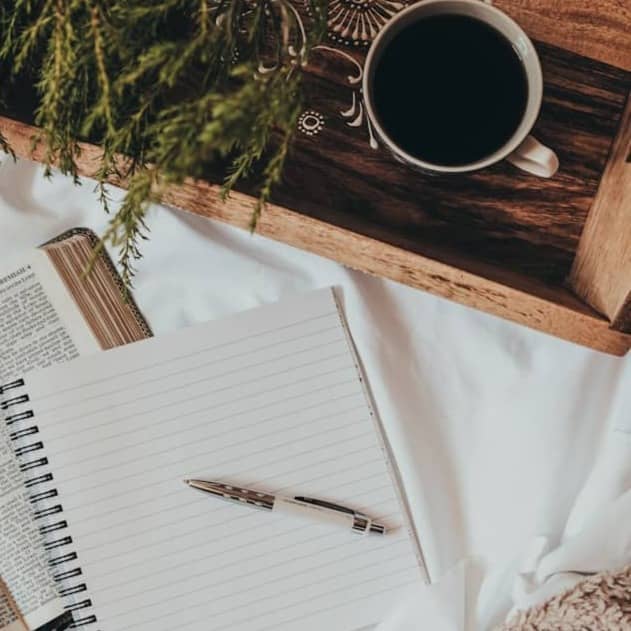 white notebook on white textile