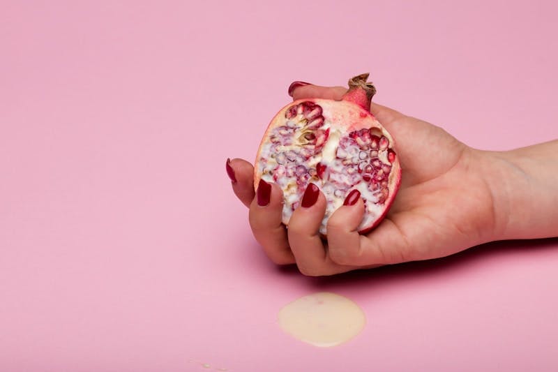 person holding red and white fruit