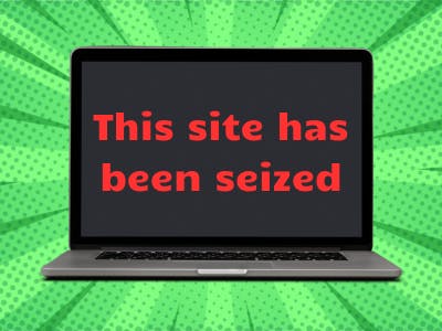 A laptop with the message "This site has been seized" displayed on the screen.