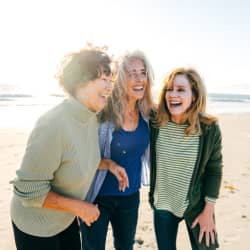 Friends laughing on the beach