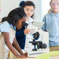 Student looking through microscope