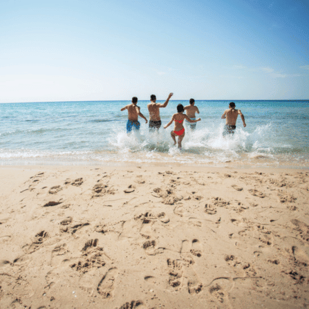 Group running into the water