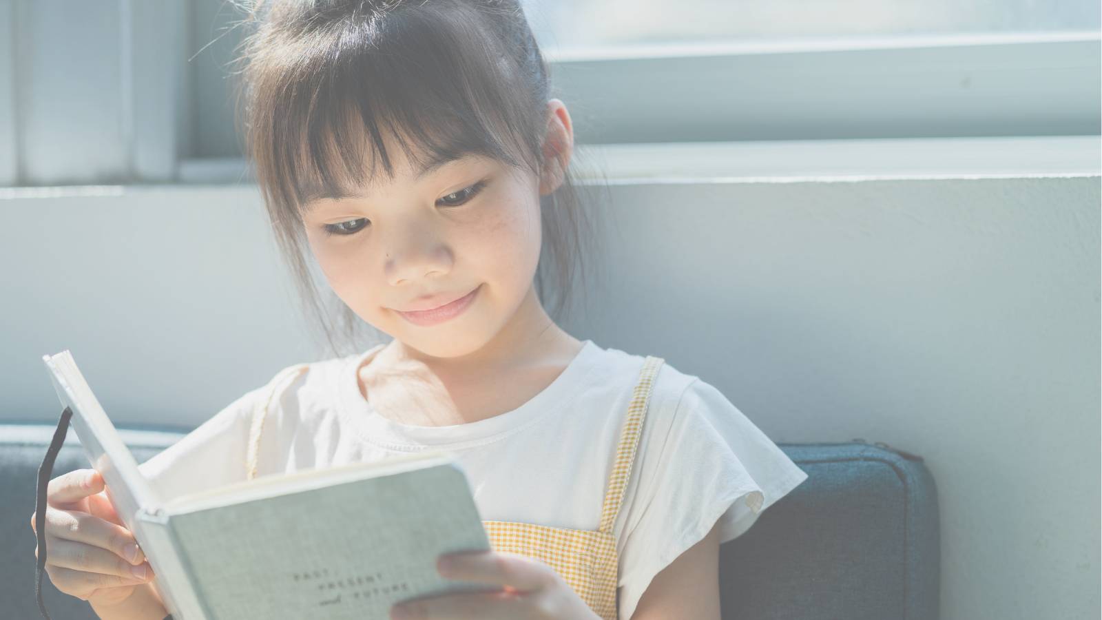 a young girl reading a book