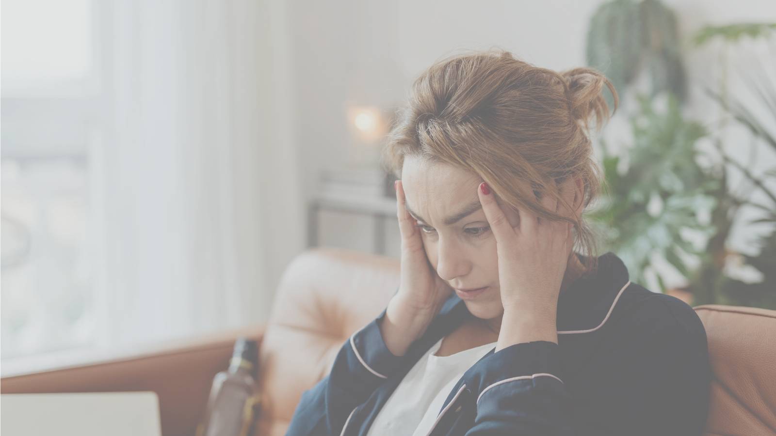 a lady feeling overwhelmed on the couch