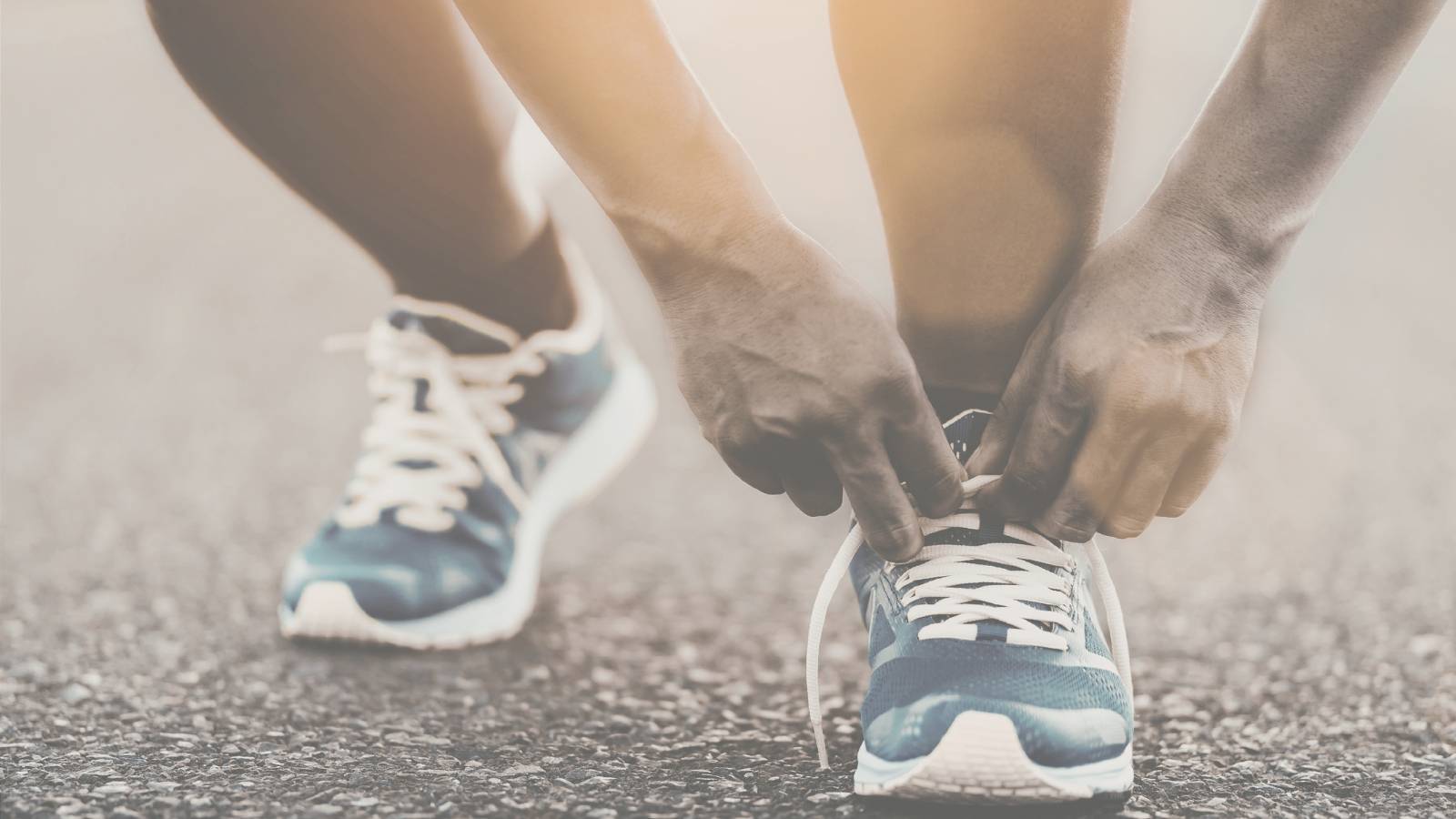a man putting on running shoes