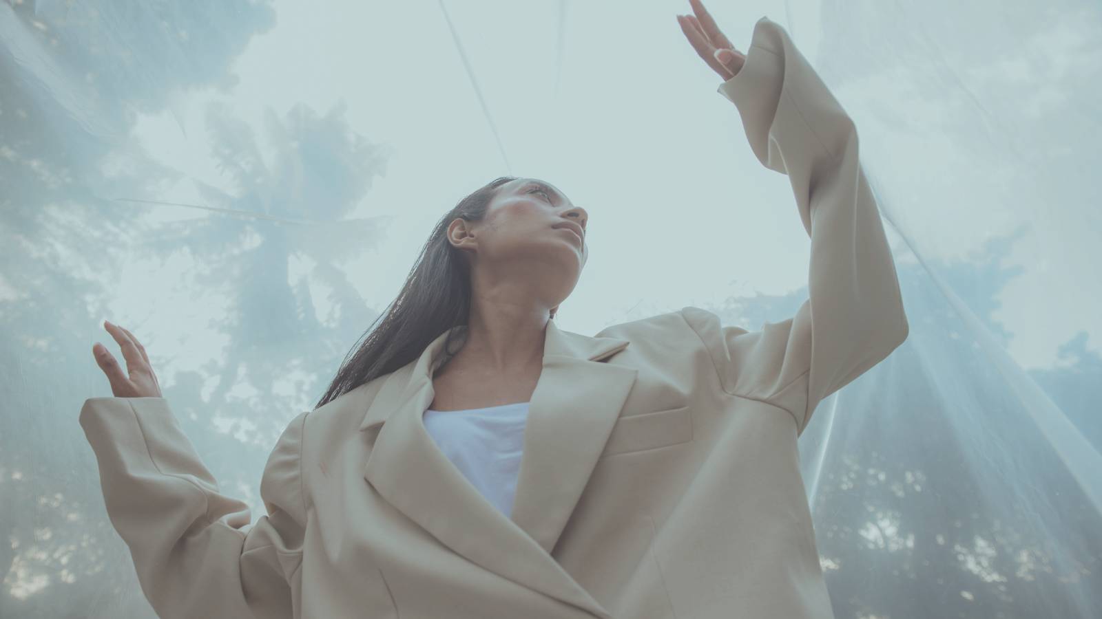lady behind curtain palms
