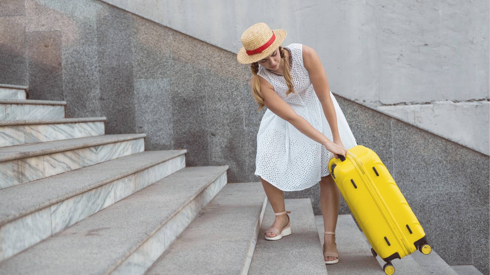 a lady carrying a suitcase up stairs
