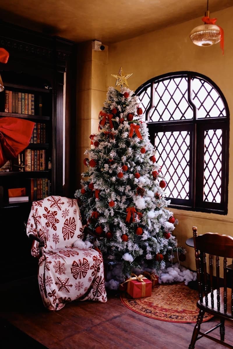A decorated christmas tree in a cozy room.