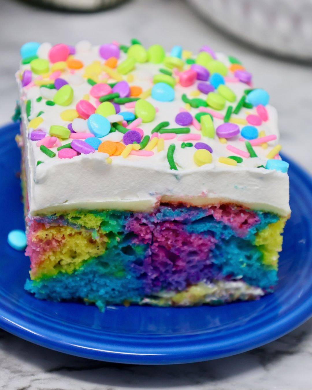 Easter Poke Cake recipe with colorful cake and sprinkles