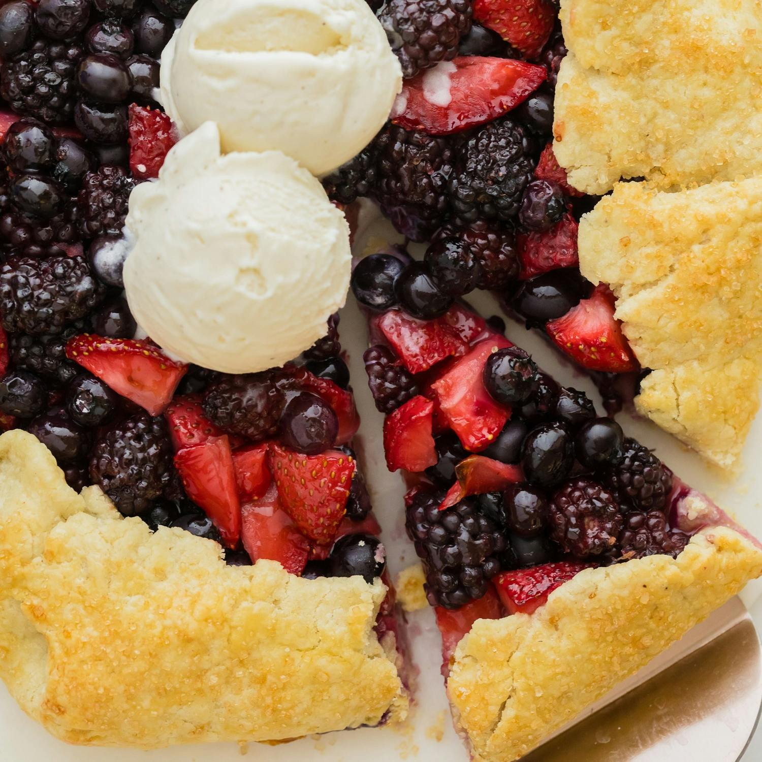Galette with mixed berries and topped with two scoops of ice cream.
