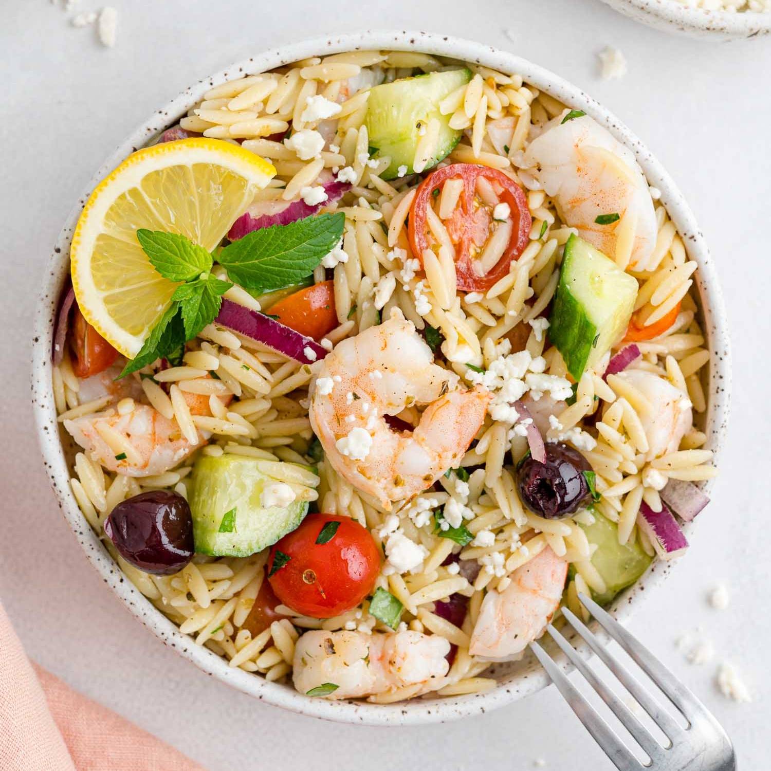 Orzo salad with shrimp, tomatoes, olive, onion.