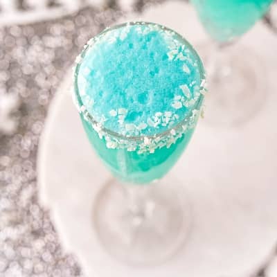 Bright blue mimosa with coconut rim.