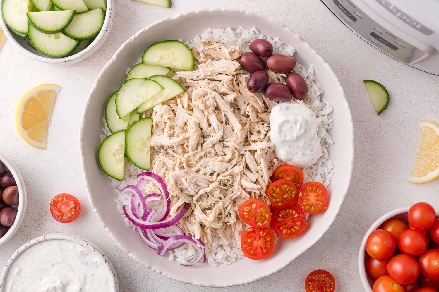 Shredded Greek chicken in a bowl with rice, 